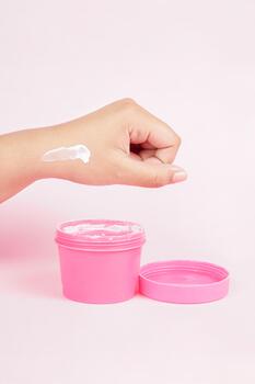 The body mask is shown with its lid open against a pink background, creating a soft and inviting look photo
