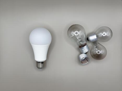 Modern LED lamp, saving electricity light bulb Non-working light bulb, broken light bulb. Concept of light and dark, idea, electricity copy space, flay lay, top view gray background photo