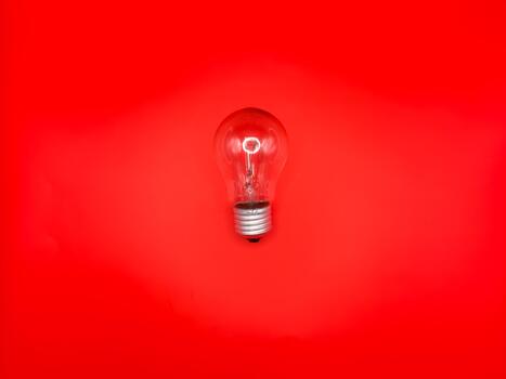 Tungsten light bulb lamp. Non-working light bulb, broken light bulb. Concept of light and dark, idea, electricity copy space, flay lay, top view. red background photo