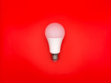 Modern LED, saving electricity. Tungsten light bulb lamp. Non-working light bulb, broken light bulb. Concept of light and dark, idea, electricity copy space, flay lay, red background photo