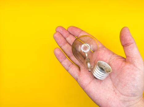 Tungsten light bulb lamp. Non-working light bulb, broken light bulb. Concept of light and dark, idea, electricity copy space, flay lay, top view. High quality photo