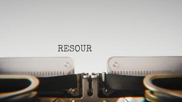 Old mechanical typewriter typing Resources Allocated in a close up view, with metal letters striking the white paper. video