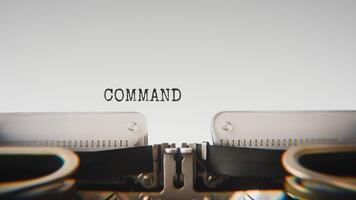 Old mechanical typewriter typing Command Center Online in a close up view, with metal letters striking the white paper. video