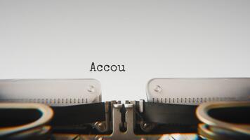 Old mechanical typewriter typing Account Responsibility in a close up view, with metal letters striking the white paper. video