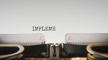 Old mechanical typewriter typing Implementation in a close up view, with metal letters striking the white paper. video