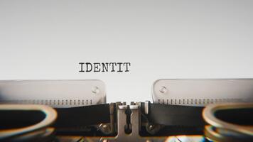 Old mechanical typewriter typing Identity Verify in a close up view, with metal letters striking the white paper. video