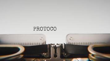 Old mechanical typewriter typing Protocol Active in a close up view, with metal letters striking the white paper. video