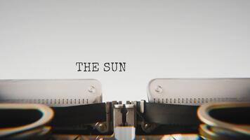 Old mechanical typewriter typing The Sun Set Behind Mountains in a close up view, with metal letters striking the white paper. video