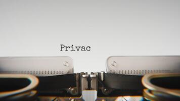 Old mechanical typewriter typing Privacy Protection in a close up view, with metal letters striking the white paper. video
