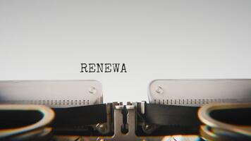 Old mechanical typewriter typing Renewable Resources in a close up view, with metal letters striking the white paper. video