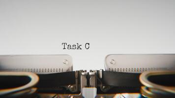 Old mechanical typewriter typing Task Completed in a close up view, with metal letters striking the white paper. video