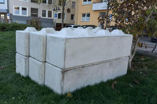 Concrete block structure in a residential area with grass photo