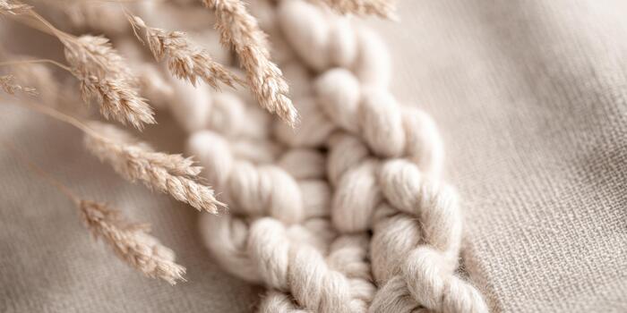 Knotting fibers with dried plants in a simple design photo