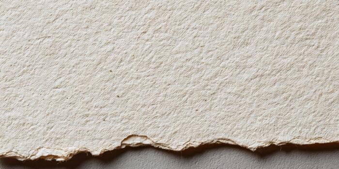 Textured handmade paper with rough edges for crafts photo