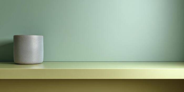 Simple decorative arrangement with a gray pot on a shelf photo