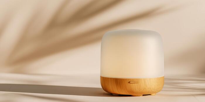 Softly glowing lamp on a natural wooden surface with shadows photo