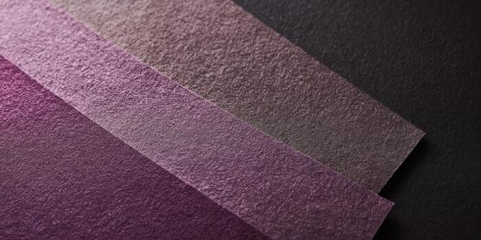 Colorful textured paper strips displayed on a dark background photo