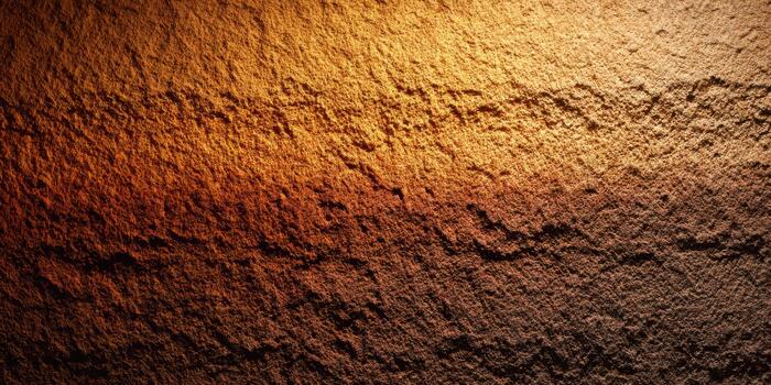 Texture of a rough brown surface illuminated by warm light photo