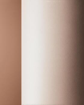 A smooth, creamy wall transitions into a soft, warm tan hue photo