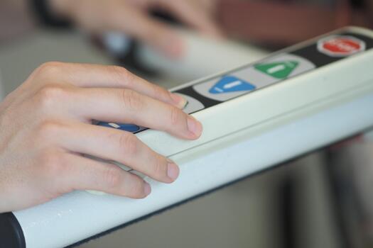 Hand pressing buttons on a control panel in a calm setting photo