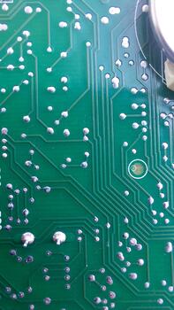 A close up of a green electronic circuit board photo