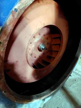 Detailed View of a Fan Blade Showcasing Intricate Design Within a Mechanical Environment photo