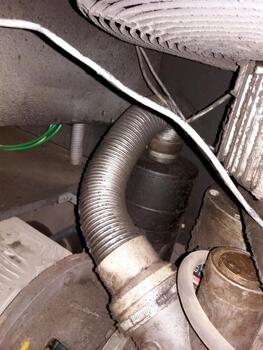 A close up of a gas tank with a hose attached photo