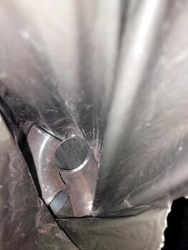 A close up of a metal pipe with a hole in it photo