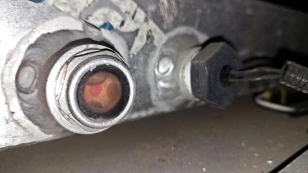 Detailed View of an Oil Sump Plug in a Vehicle Maintenance Environment With Tools Nearby photo