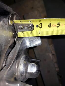 A close up of a metal object with a measuring tape photo