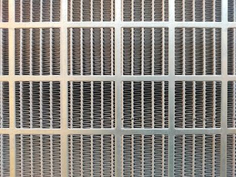 A close up of a metal grille with a grid pattern photo