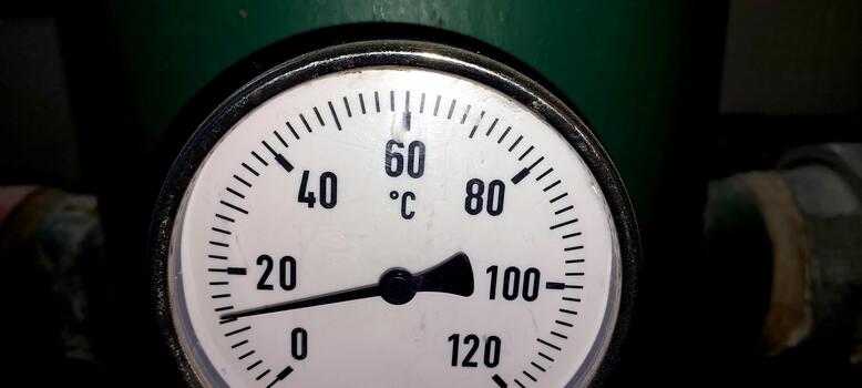 A thermometer is shown on a green pipe photo