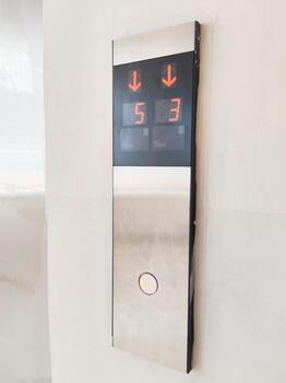 Modern Elevator Call Button Panel Showing Digital Floor Numbers and Directional Arrows photo