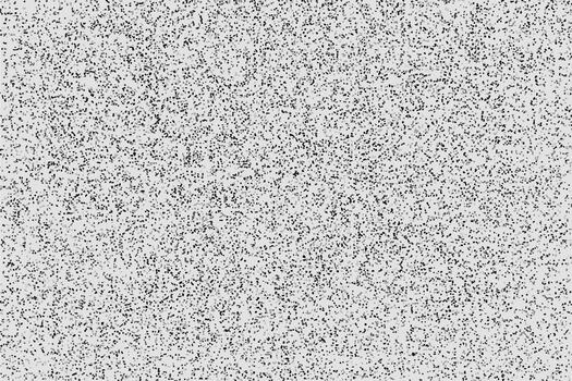 Abstract monochrome textured background with a dense pattern of irregular speckles and subtle variations in tone vector