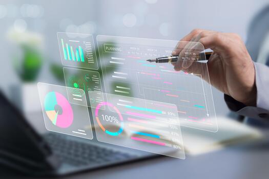 Management concept of planning and executing schedule to track progress by analyzing graphs and virtual documents placed on table. Businessman working with laptop device. photo