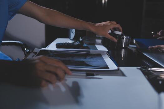 A doctor is examining an x - ray image on a computer photo