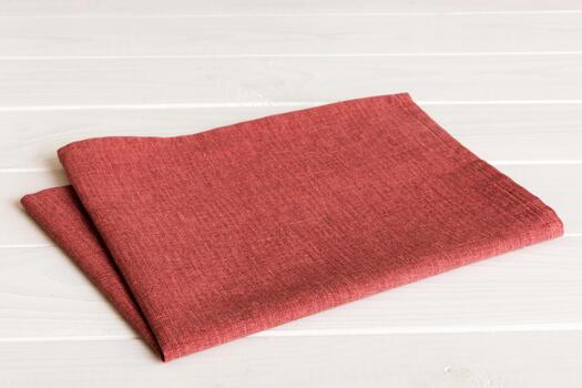top view with red empty kitchen napkin isolated on table background. Folded cloth for mockup copy space, photo