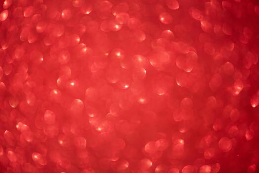 Defocus light red color. Glittery blurred sparkles as background. photo