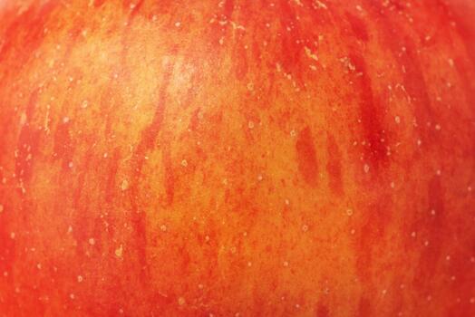 Texture of red apple with yellow color as background macro photo. photo