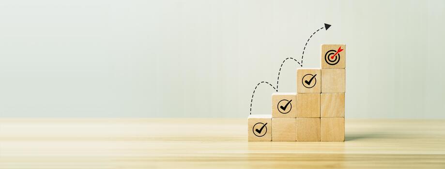 Goal achievement and business success concept with wooden block steps showing checklist icons leading to target dartboard, symbolizing strategy, planning, progress, and successful performance growth photo