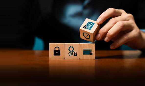 Cybersecurity and data protection concept with businessman hand stacking wooden blocks with lock, shield, ID icons, symbolizing privacy, compliance, secure system, risk management, information safety photo