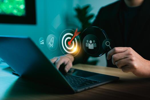 Business analysis and target audience strategy with businessman using laptop computer and magnifying glass focusing on digital marketing goal surrounded by growth chart, teamwork and search innovation photo