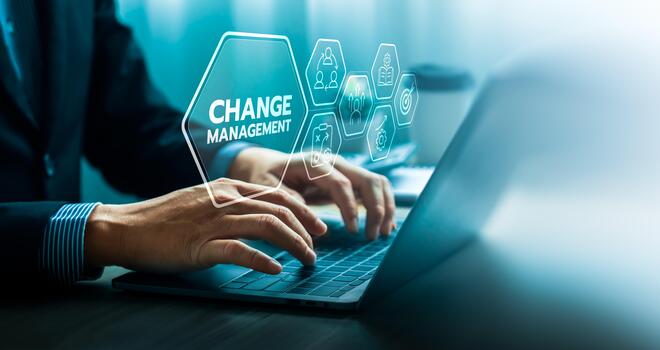 Change management concept with businessman using laptop and virtual interface icons representing leadership, teamwork, strategy, and learning for organizational transformation and business improvement photo