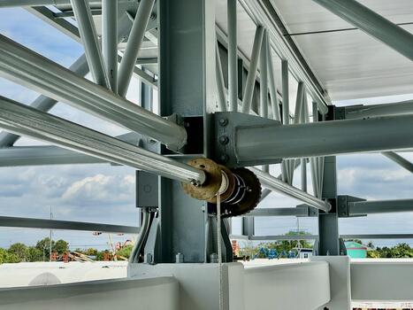 Steel structure framework with a mounted rope winch system in an industrial building, showing detailed construction and engineering design. photo