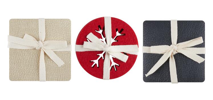 Bright red round coaster with a snowflake pattern cut out in the center cut out isolated white background with clipping path photo