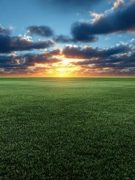 Sunset over a vast green field with dramatic cloud formations photo