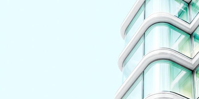 Modern glass building with unique architectural design against clear sky photo