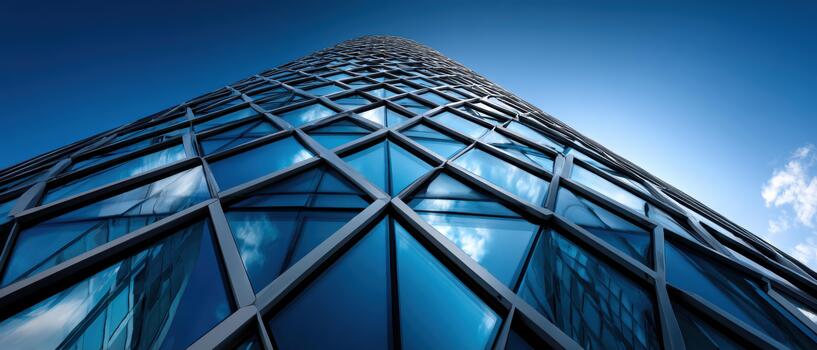 Modern glass building reflecting the sky in city architecture photo