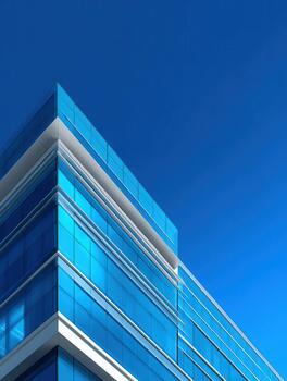Modern glass building against a clear blue sky showcasing sleek architecture design photo