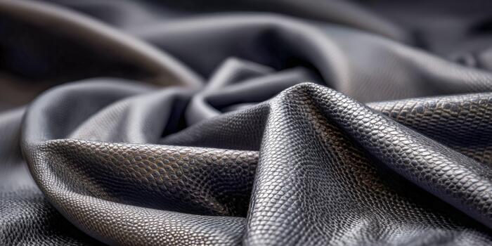 Textured black fabric draped artistically in a soft lighting environment photo